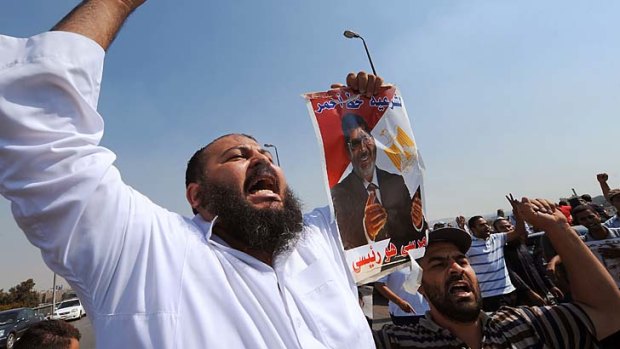 A supporter of Mohamed Mursi protests in Cairo: Police will no longer try to forcefully clear the sit-ins.