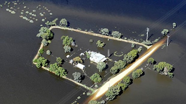 Floodwaters besiege a farmhouse near Kerang.