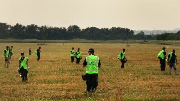 Australian Federal Police with their Malaysian and Dutch counterparts at the MH17 crash site.