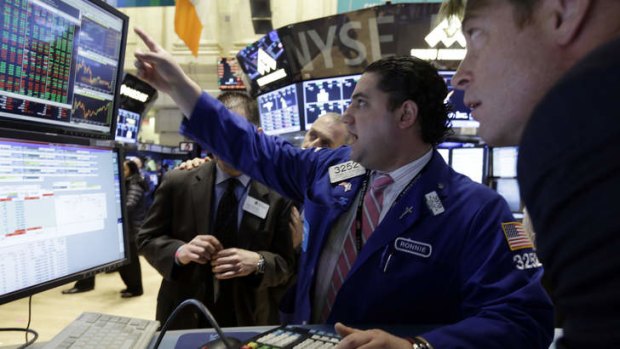 Up and away: Wall Street traders watch as new highs are struck.