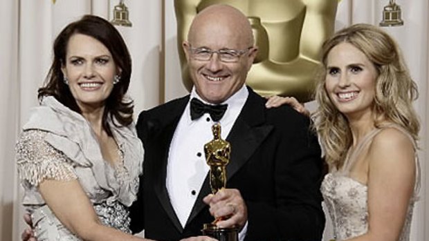Heath Ledger's mother Sally Bell, father Kim Ledger, and sister Kate Ledger hold his Oscar for best supporting actor.