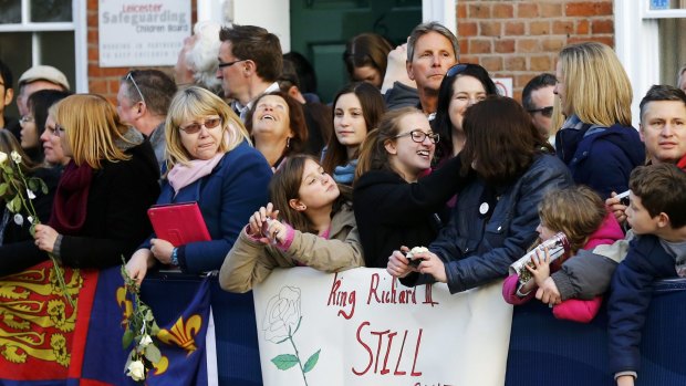 Locals await the procession carrying Richard III's coffin in Leicester.