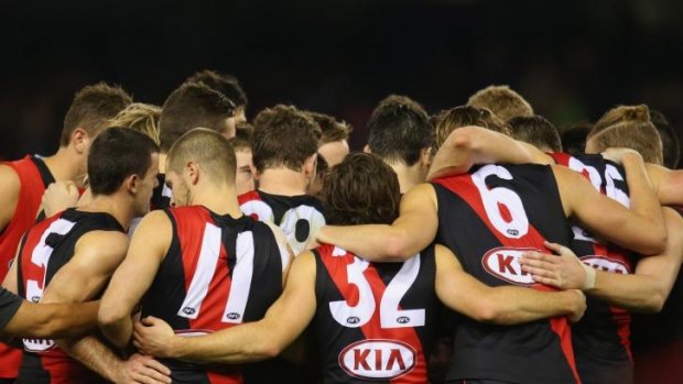 The Essendon Bombers form a huddle during the round 14 AFL match with the Adelaide Crows in July.