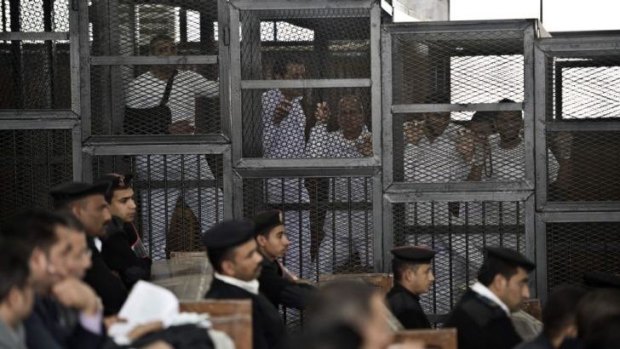 Peter Greste (centre) with fellow accused in the "defendants' cage" at Cairo's Tora prison.