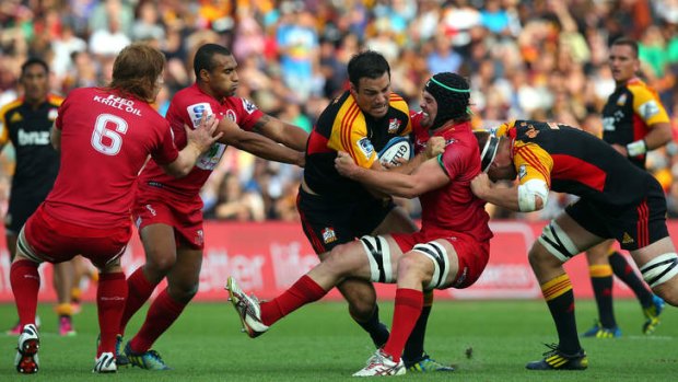 High praise ... the Reds neutralise Richard Kahui of the defending champion Chiefs.  Australia's Super Rugby sides have been lauded by All Blacks coach Steve Hansen.