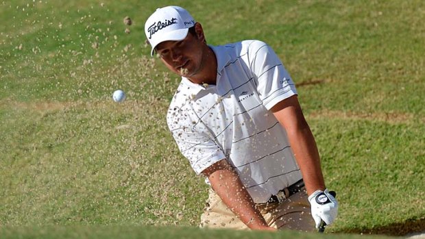 Rare form ... first-round leader Daniel Popovic blasts from a bunker during his stunning round of 64 at Coolum.