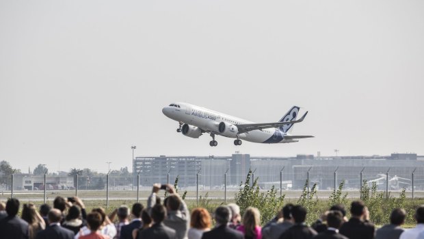 Spectators watch the first Airbus A320neo take off on its debut flight at Toulouse-Blagnac airport.