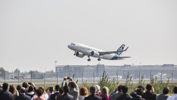 Spectators watch the first Airbus A320neo take off on its debut flight at Toulouse-Blagnac airport.