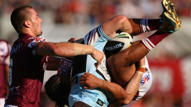 Ben Pomeroy of the Sharks is tackled by Steve Matai of the Sea Eagles during the round six NRL match at Brookvale Oval.