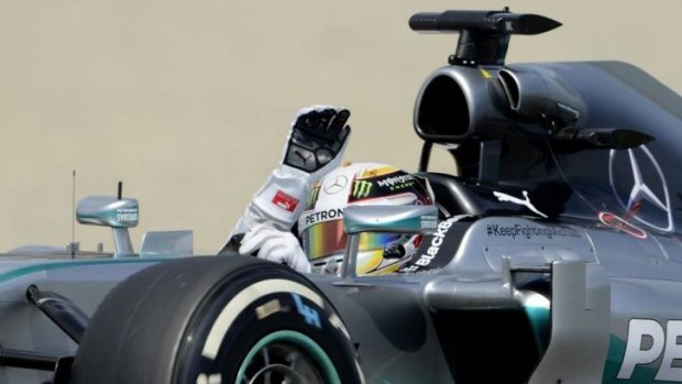 Lewis Hamilton waves after the qualifying session for the Spanish Formula One Grand Prix.