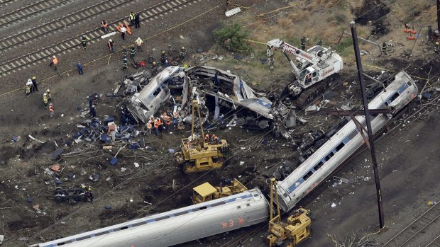 Emergency personnel work at the scene of the deadly Amtrak train derailment.