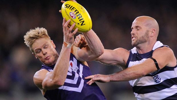 Fremantle's Adam McPhee outmarks Geelong's Paul Chapman during the Dockers' stunning upset of the Cats at the MCG in September.