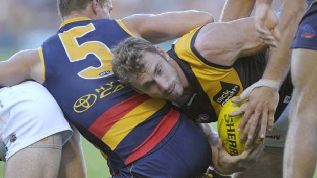 Richmond midfielder Shane Tuck desperately tries to get the ball out of the pack during yesterday's game against the Crows in Adelaide.