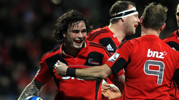 Zac Guildford of the Crusaders celebrates his try with teammate Andy Ellis.