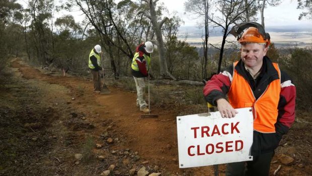 Track specialists Mike Long and Chris Short with Makin Trax managing director Darren Stewart (front) working on the Canberra Centenary Trail on Mount Ainslie.