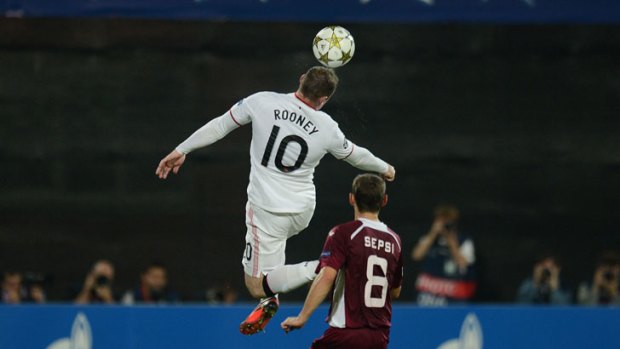 Manchester United's Wayne Rooney rises above Cluj's Laszlo Sepsi during their Champions League match in Romania.