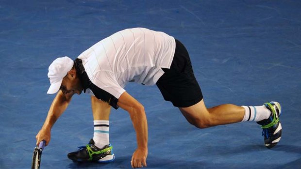 Andy Roddick reacts after falling awkwardly on the court during his match against Lleyton Hewitt.