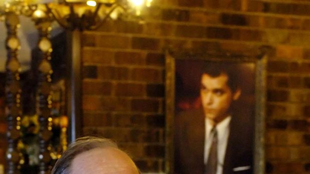 "The money was unbelievable" ... a portrait of Ray Liotta playing him in Goodfellas hangs behind Henry Hill at the Firefly restaurant in North Platte, Nebraska.