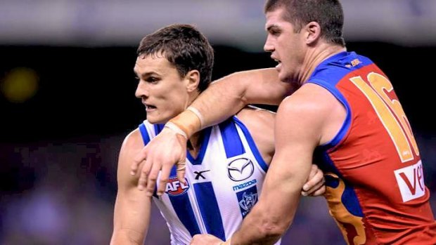 North Melbourne's 2013 Syd Barker medallist, Scott Thompson (left), tussles with Brisbane Lions forward Jonathan Brown in round four this year.