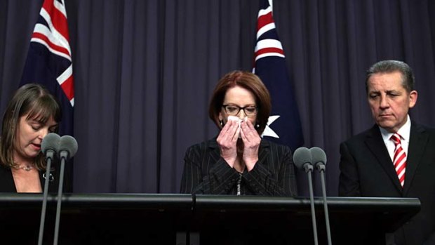 Prime Minister Julia Gillard, centre, with outgoing Attorney-General Nicola Roxon and Senator Chris Evans.