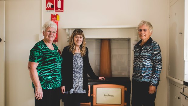 Robyn Gowing (nee Vest), Jenni Farrell, and Beth Gibbs in the kitchen of the cottage with the original Metters Canberra stove. "A bucket and a half of pine cones cooks a cake','' Jenni said.