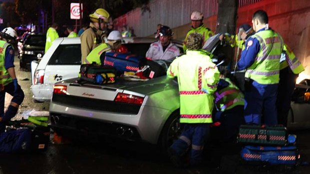 Rescue effort &#8230; emergency personnel work to free a 21-year-old man from a $500,000 Lamborghini.