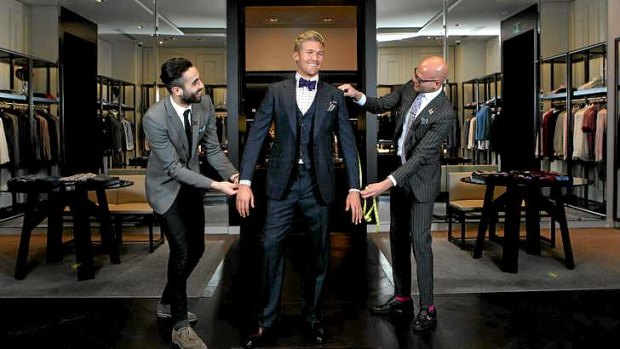Flair for cup fashion: Karim Gaaloul, left, and Luca Bronzino, right, of luxury menswear shop Harrolds, help Dan Murray try on clothes.