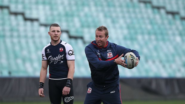 Demonstration: Sydney Roosters coach Trent Robinson shows Jackson Hastings a move during training at Allianz Stadium.