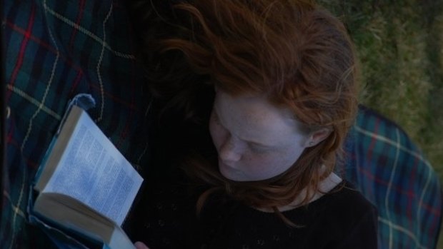 Liv Hewson deep in a book during her childhood in Canberra. Words, stories, language have always been important to her.