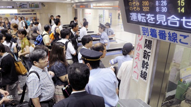 People get stranded at Tokyo Station of the Tokaido Bullet Train in Tokyo.