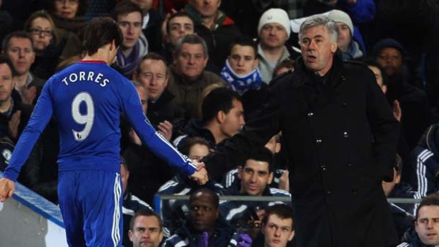 Debut to forget .... Fernando Torres shakes hands with Chelsea boss Carlo Ancelotti after being substituted.