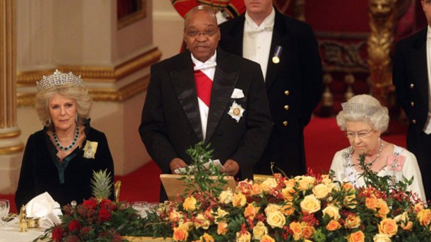 Britain's Queen Elizabeth II, right, Camilla, the Duchess of Cornwall, left and South African President Jacob Zuma, seen, at the start of the State Banquet at Buckingham Palace,  in London.