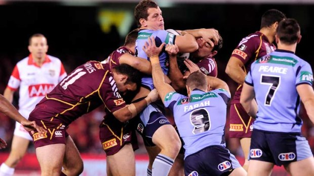 Carried away ... Greg Bird gets plenty of attention from Queensland.