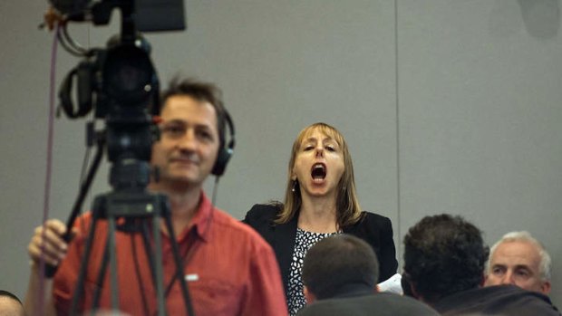 Medea Benjamin, a protester and co-founder of Code Pink, shouts as US President Barack Obama speaks about his administration's drone and counterterrorism policies, as well as the military prison at Guantanamo Bay, at the National Defense University in Washington, DC, May 23, 2013.