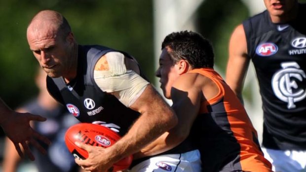 Wrapped up &#8230; Dylan Shiel clashes with Chris Judd.