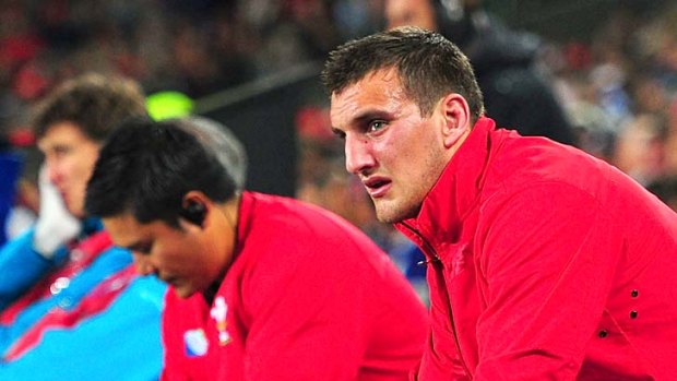 Distressed ... Wales captain Sam Warburton  looks on from the bench after being sent off.