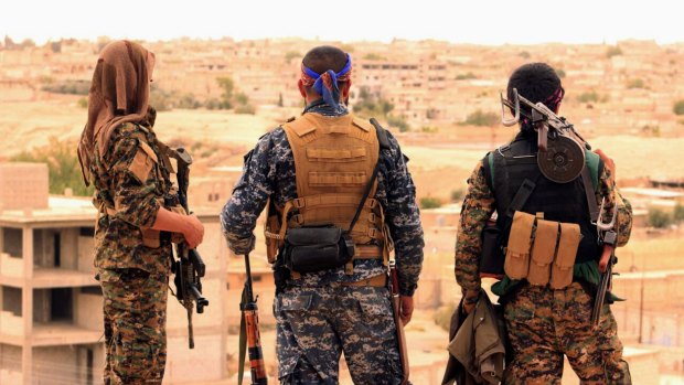 Fighters from the US-backed Syrian Democratic Forces looking towards the town of Tabqa, Syria. 