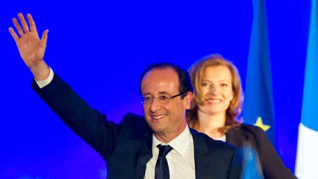 Behind her man ... Francois Hollande celebrates victory next to his partner Valerie Trierweiler.
