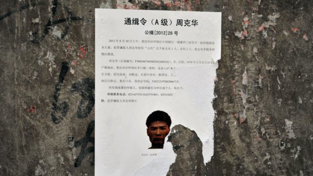 Eight years on the run ... Zhou Kehua appears on a wanted poster.
