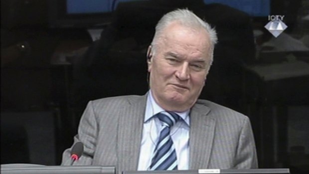 Former Bosnian Serb military chief General Ratko Mladic smiles during his appearance at the Yugoslav war crimes tribunal in the Hague in 2014.
