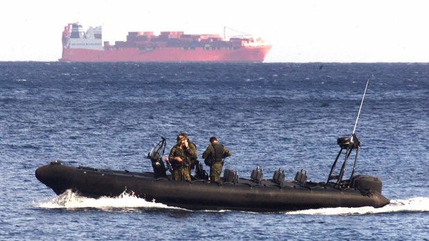 Boat-borne politics: An Australian Army vessel patrols the waters near Norwegian freighter Tampa in 2001. 