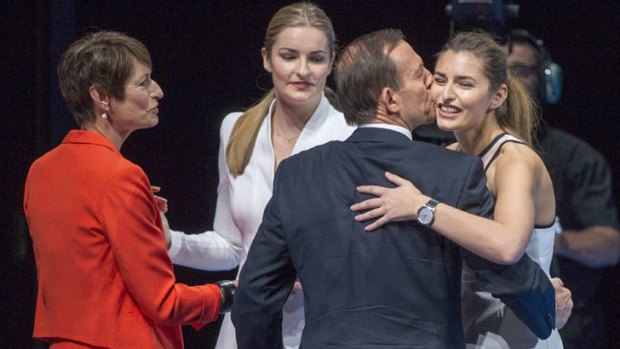 Got his back: Tony Abbott plants one on daughter Frances at the Coalition's campaign launch, as wife Margie and the couples other daughter Bridget look on.