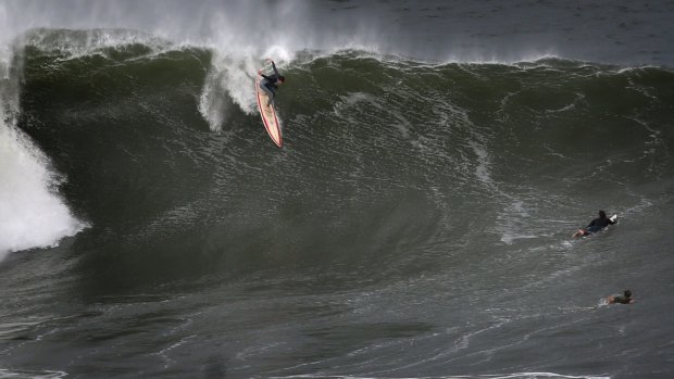 Enthusiastic surfers take on giant waves at the north end of Coogee Beach.