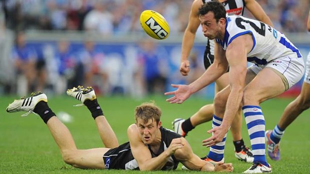 Collingwood's Ben Reid, who booted five goals, is spoilt by Kangaroo Todd Goldstein.