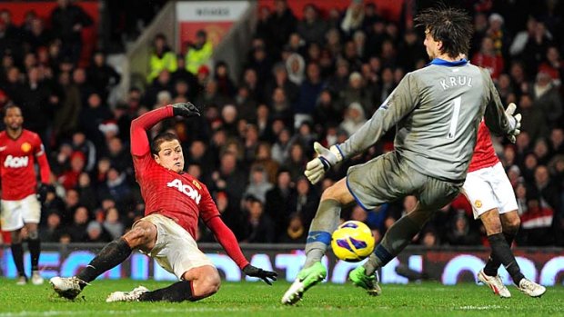 The closer ... Javier Hernandez slides the ball past Newcastle's Tim Krul to secure a thrilling last-minute victory.