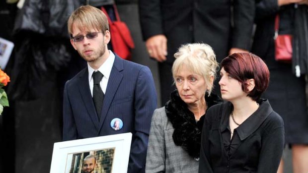 Ham's former partner, Linda Wostry (centre) and their two children, Max and Camille, at yesterday's private funeral service at the Fitzroy Town Hall.