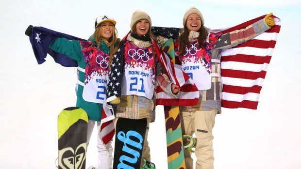 Silver medalist Torah Bright of Australia, gold medalist Kaitlyn Farrington of the United States and bronze medalist Kelly Clark of the United States celebrate during the flower ceremony.