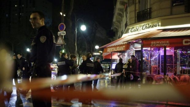 French police investigate at a restaurant in Paris where a man and a woman were shot dead at close range before the shooter fled the scene.