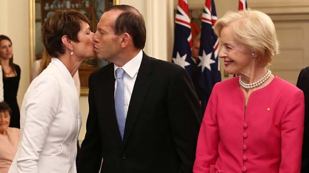 Tony Abbott kisses his wife Margie after he was sworn  in as Australia's 28th Prime Minister by Governor-General Quentin Bryce, right.