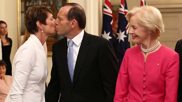 Tony Abbott kisses his wife Margie after being sworn in as Australia's 28th Prime Minister by Governor-General Quentin Bryce, right, today.